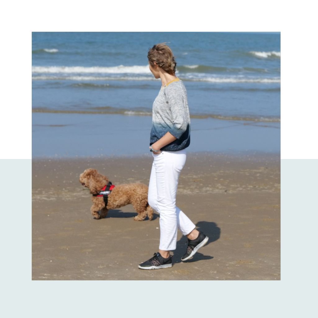 Anna walking on the beach with her dog Max