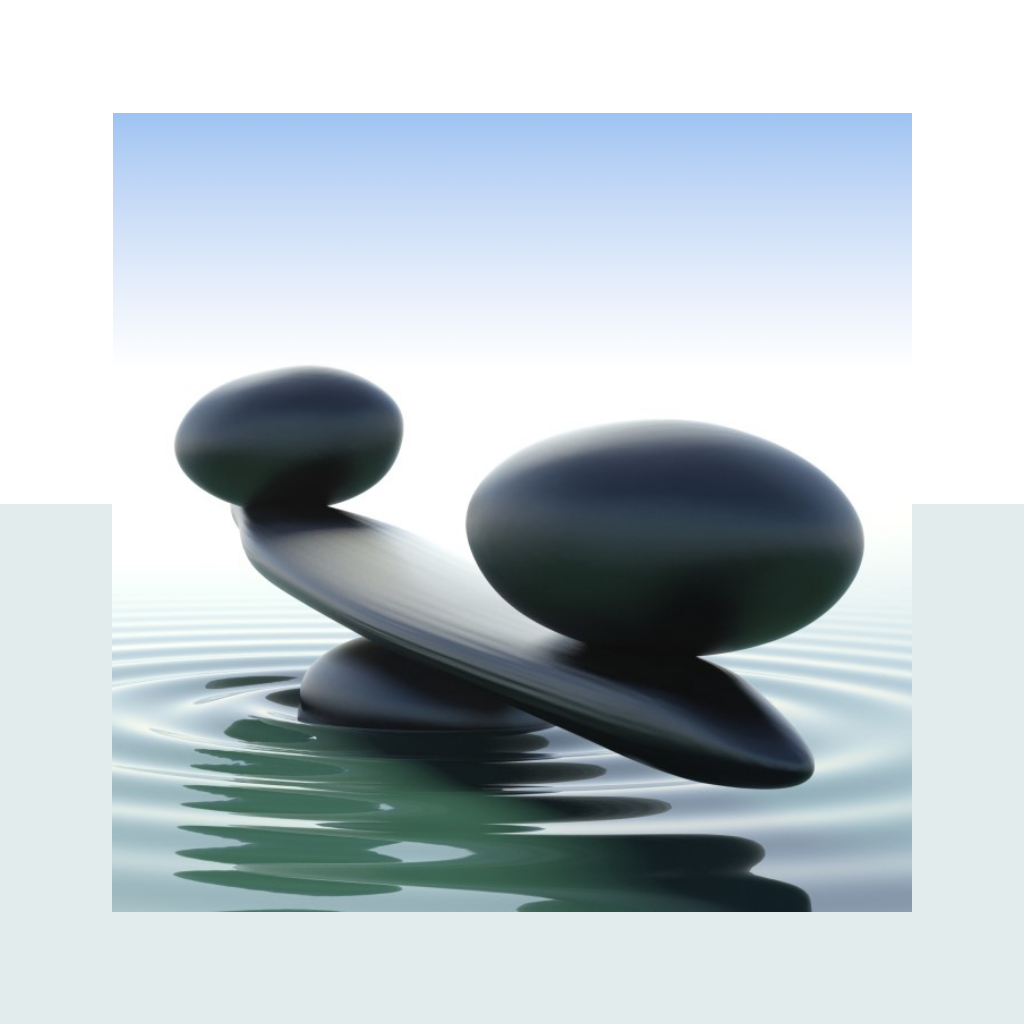 Dark balanced stones resting on calm water with soft ripples under a pale blue sky
