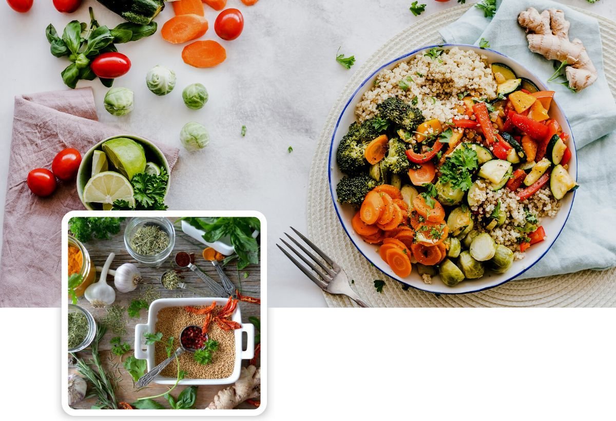 A bowl of grains and roasted vegetables next to fresh tomatoes and herbs, with a small framed photo of a kitchen counter with herbs and a baking dish
